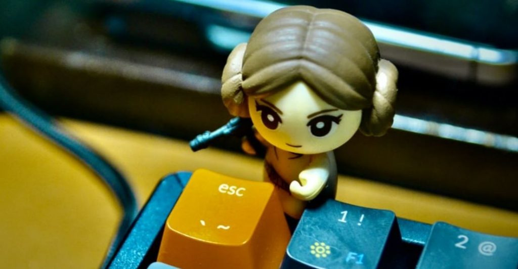 Lego figure next to the Escape key on a keyboard