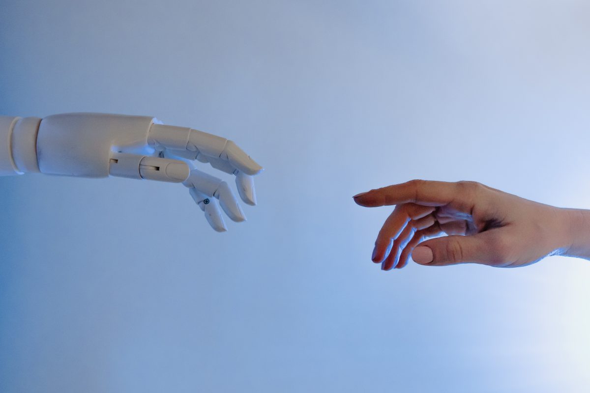 A robot hand, reaching out to a human hand