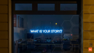 A blue, electric sign in a shop window says "what's your story?"
