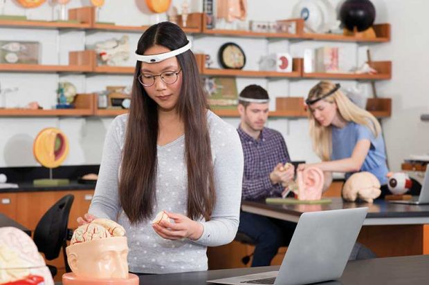 Students wearing head-mounted brain monitoring devices