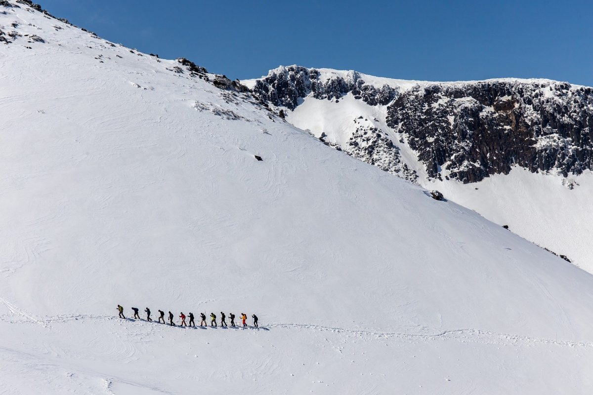 Mountain climbers in a white landscape