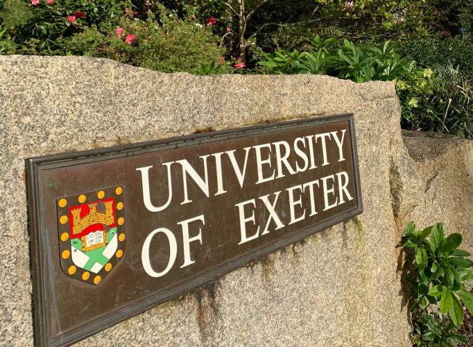 Photo of the University of Exeter logo at the entrance to the Streatham Campus.