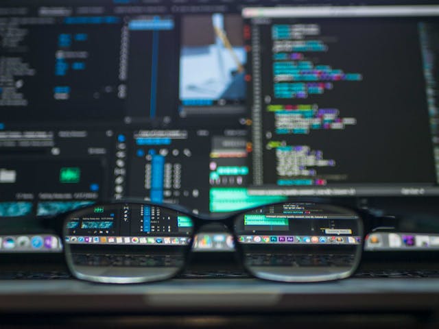 glasses over laptop with data analytics on the laptop screen