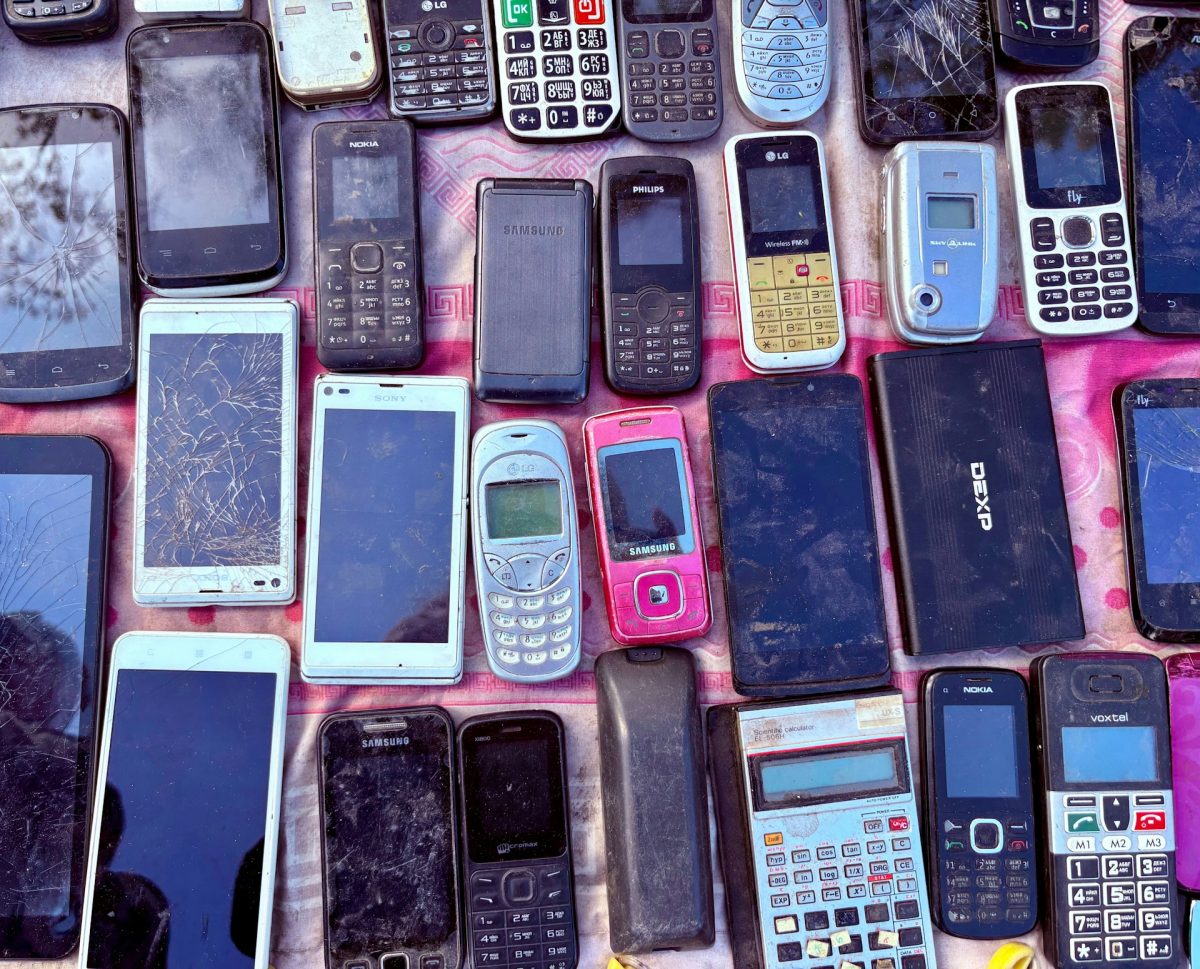 A variety a mobile phones are displayed. There are older and newer models.