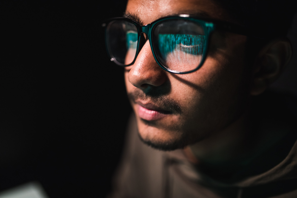 close up of man wearing glasses, there is a digital overlay on his glasses to represent smart glasses